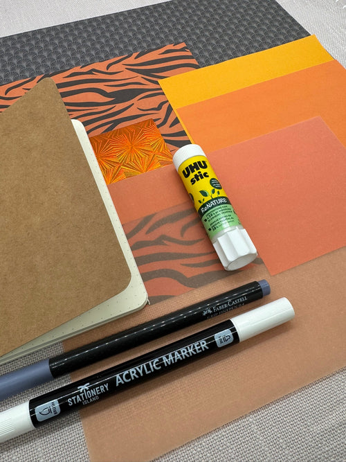 Schreibwarenset mit orangenem Designpapier, Kleber und Stiften