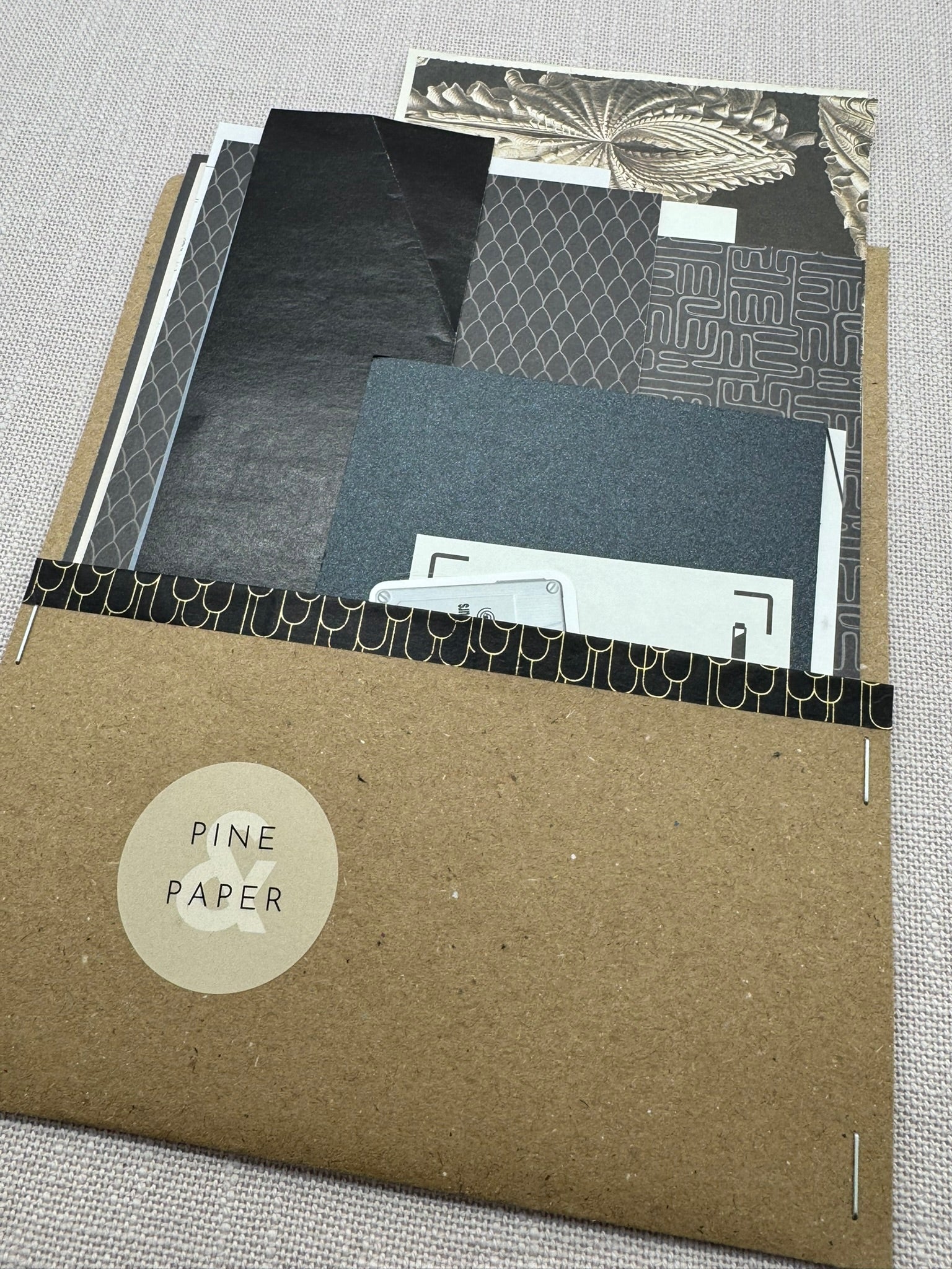 Ein Umschlag aus Kraftpapier mit diversen Papierstücken für Basteln, Scrapbooking, Collagen